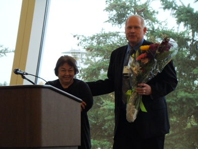 Claire Lammerts receives bouquet from Chip Ray, outgoing board president NYHousing Oct 2011 annual meeting posted on MHProNews.com credit Tony Kovach